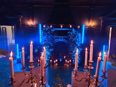 Ein festlich dekorierter Raum mit Kerzenleuchtern und bunten Lichtern. Photo by DJ Mirko Anders