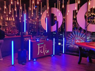 Bunte Beleuchtung und eine Bar mit "Felix" Schriftzug in einem modernen Veranstaltungsort. Photo by DJ Mirko Anders